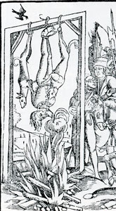 Reversed hanging of a Jew with dogs